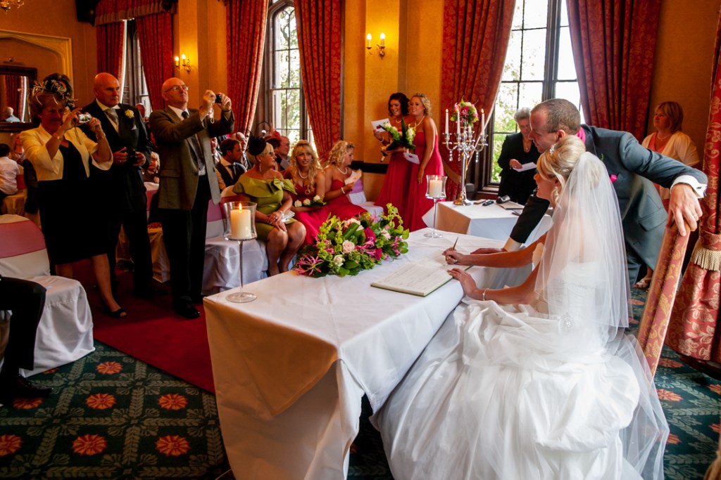 Guests take photos of the bride and groom during the ceremony, at Shropshire wedding venue, Rowton Castle.