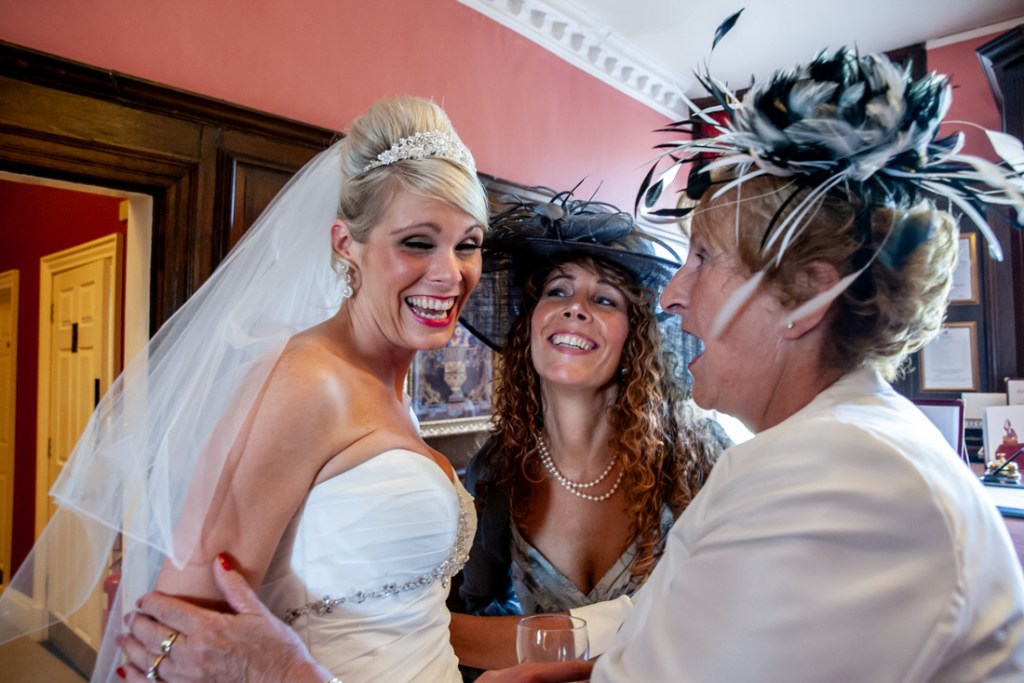 The bride laughs with guests at Shropshire wedding venue, Rowton Castle.