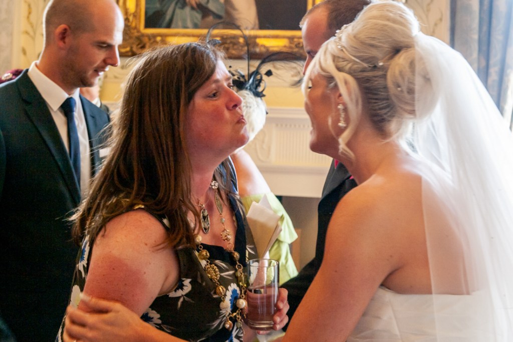 Guest goes to kiss the bride at Shropshire wedding venue, Rowton Castle.