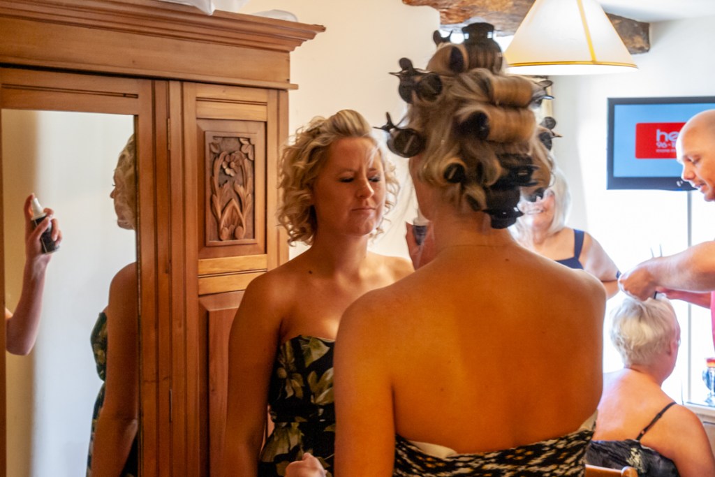 A bridesmaid has her face sprayed during the bridal preparations at Rowton Barns near Shropshire wedding venue, Rowton Castle.