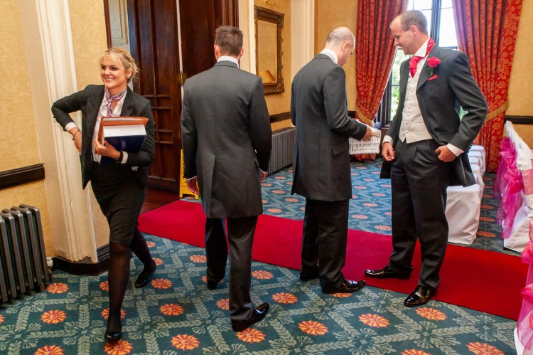 The wedding planner and groomsmen before a wedding at Rowton Castle in Shropshire.