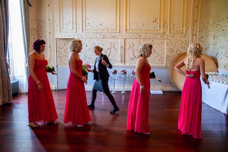 The wedding planner checks out the bridesmaids before the start of a wedding at Rowton Castle in Shropshire.