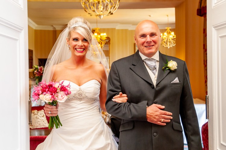 The bride and her father enter the cermony for a wedding at Rowton Castle in Shropshire.