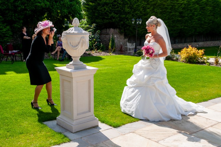 A guest takes a photo of the bride during a wedding at Rowton Castle in Shropshire.