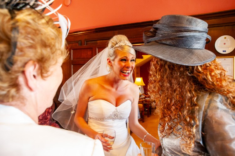 The bride laughs with guest during a wedding at Rowton Castle in Shropshire.