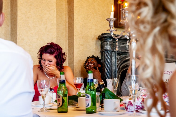 Guests laugh during the speeches at a wedding at Rowton Castle in Shropshire.