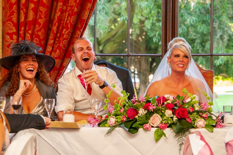 The groom laughs during the speeches at a wedding at Rowton Castle in Shropshire.