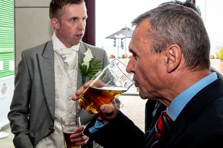 A guest enjoys a pint before a wedding at the Holiday Inn Seafront hotel in Brighton, East Sussex.