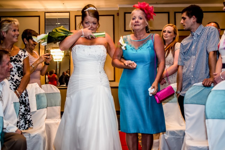 A tearful bride comes down the aisle with her mother, during a wedding at the Holiday Inn Seafront hotel in Brighton, East Sussex.
