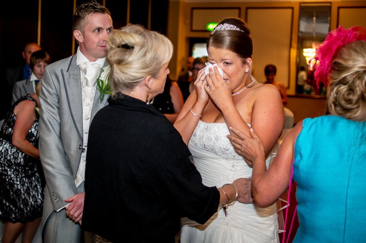 The bride tries to dry her eyes with a tissue, during a wedding at the Holiday Inn Seafront hotel in Brighton, East Sussex.