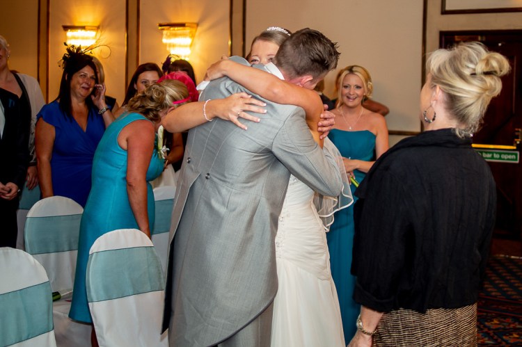 The groom gives the bride a reassuring hug, during a wedding at the Holiday Inn Seafront hotel in Brighton, East Sussex.