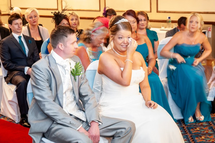 The bride continues to dry her tears, during a wedding ceremony at the Holiday Inn Seafront hotel in Brighton, East Sussex.