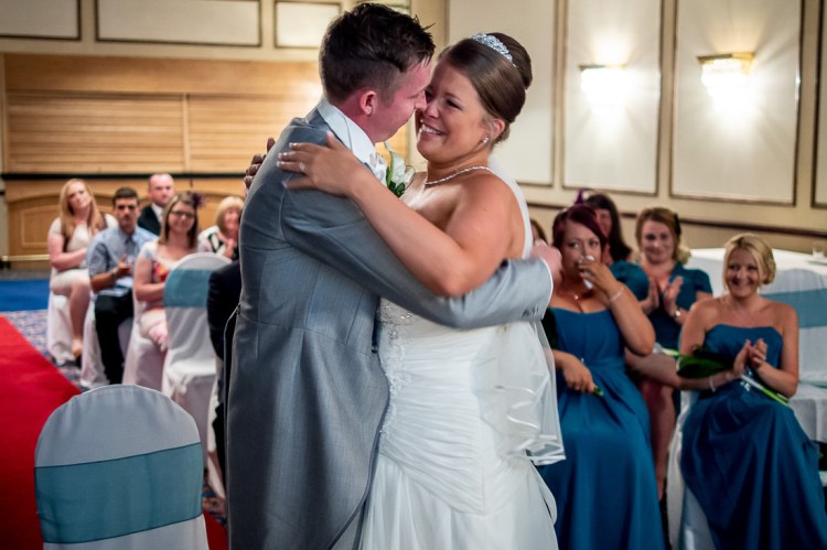 The bride and groom embrace after their first kiss, during a wedding ceremony at the Holiday Inn Seafront hotel in Brighton, East Sussex.