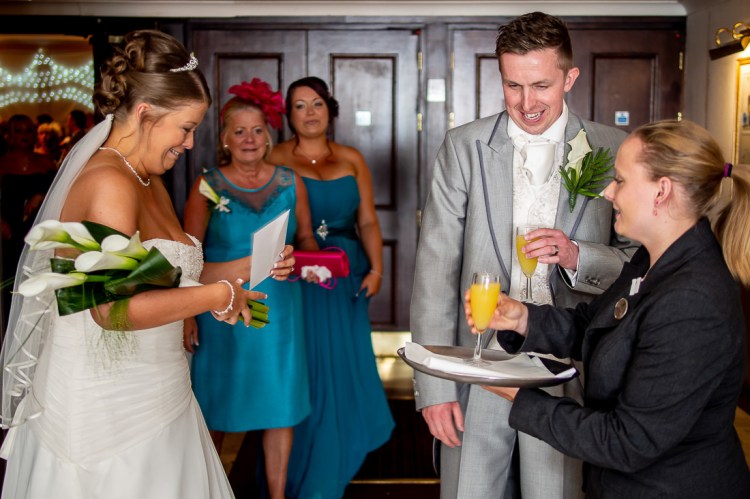 The bride and groom are offered refreshments, durig a wedding at the Holiday Inn Seafront hotel in Brighton, East Sussex.