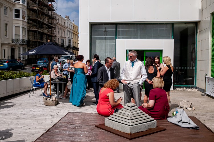 Wedding guests enjoying the seaside sunshine, during a wedding at the Holiday Inn Seafront hotel in Brighton, East Sussex.