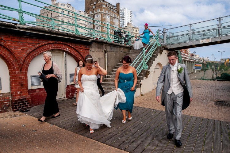 The wedding party have a walk along the seafront, during a wedding at the Holiday Inn Seafront hotel in Brighton, East Sussex.