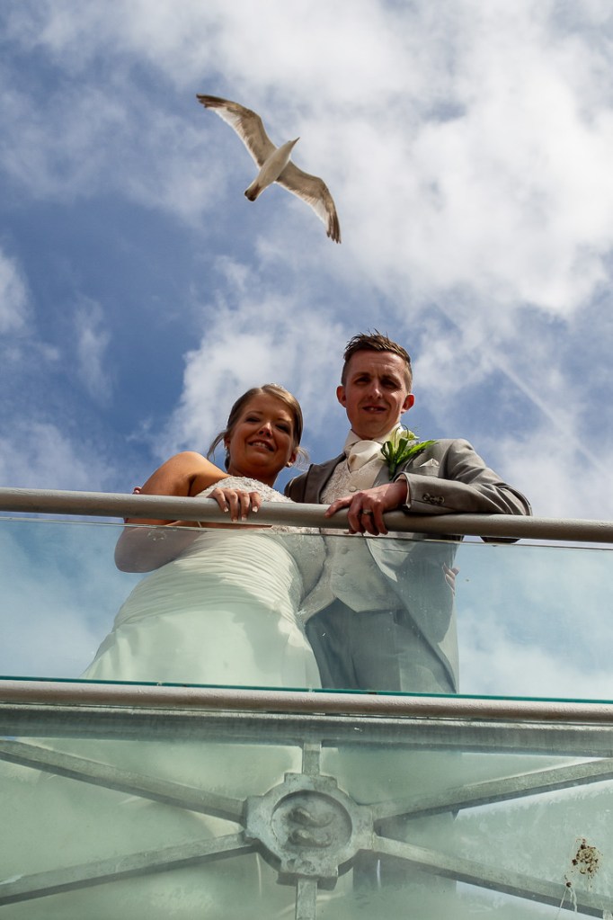 A seagull flies overhead of the bride and groom, during a wedding at the Holiday Inn Seafront hotel in Brighton, East Sussex.