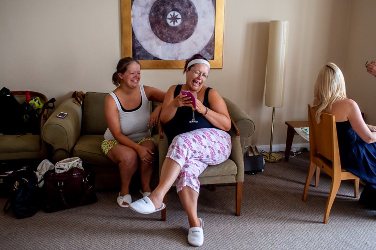Laughter during the bridal preparations, ahead of a wedding at the Holiday Inn Seafront hotel in Brighton, East Sussex.