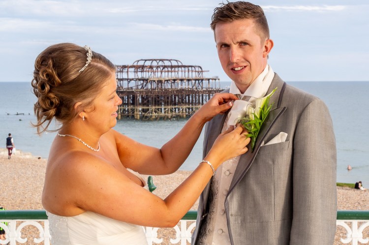 The bride adjusts the groom's cravat, during a wedding at the Holiday Inn Seafront hotel in Brighton, East Sussex.
