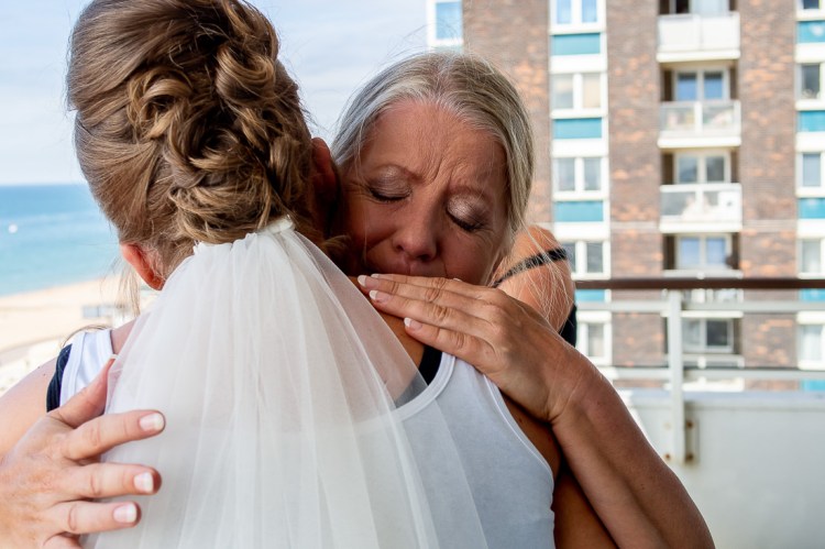 An emotional bride and mother hug, ahead of a wedding at the Holiday Inn Seafront hotel in Brighton, East Sussex.