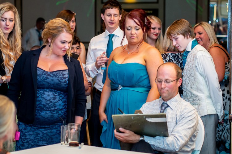 Guests watch the caricaturist during a wedding at the Holiday Inn Seafront hotel in Brighton, East Sussex.