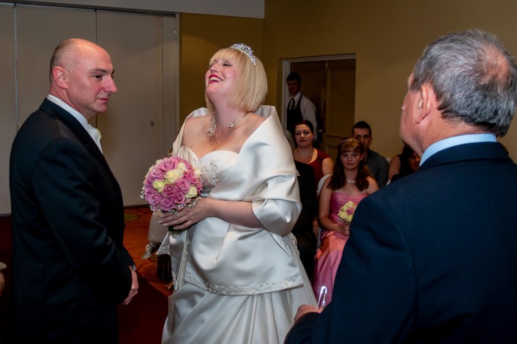 The bride laughs during a wedding ceremony at the Meon Valley Hotel, near Southampton, in Hampshire.