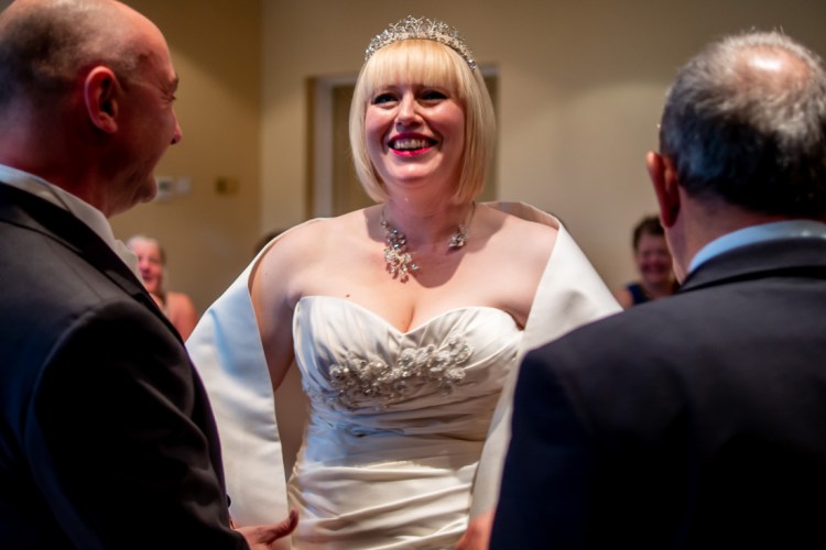 The bride giggles during a wedding ceremony at the Meon Valley Hotel, near Southampton, in Hampshire.