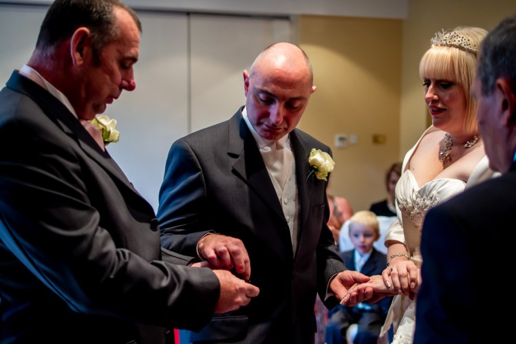 THe best man presents the rings during a wedding ceremony at the Meon Valley Hotel, near Southampton, in Hampshire.