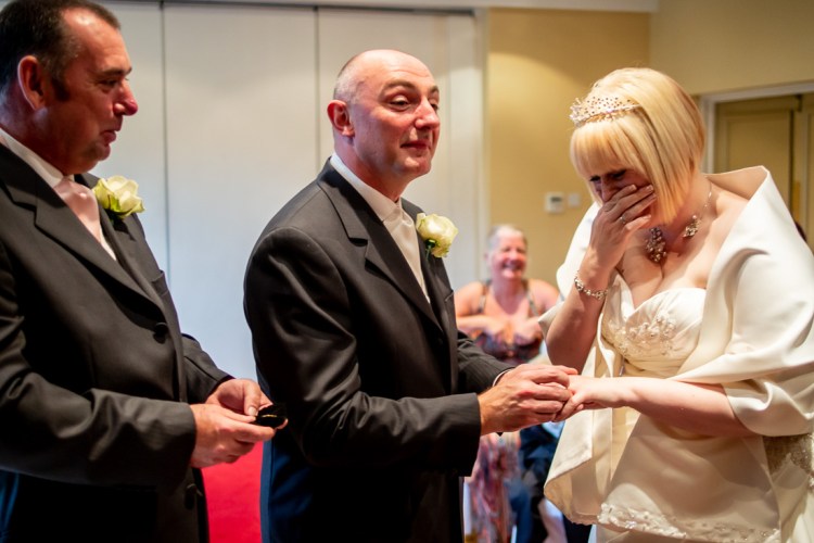 The bride laughs at the groom during a wedding ceremony at the Meon Valley Hotel, near Southampton, in Hampshire.