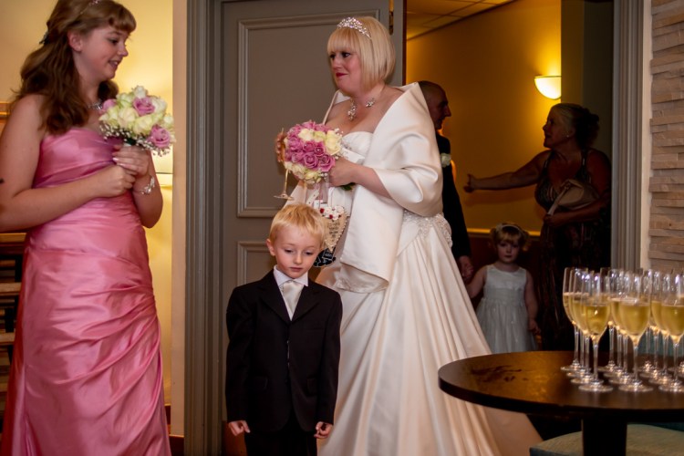 The bride and her son chat to a bridesmaid, during a wedding at the Meon Valley Hotel, near Southampton, in Hampshire.
