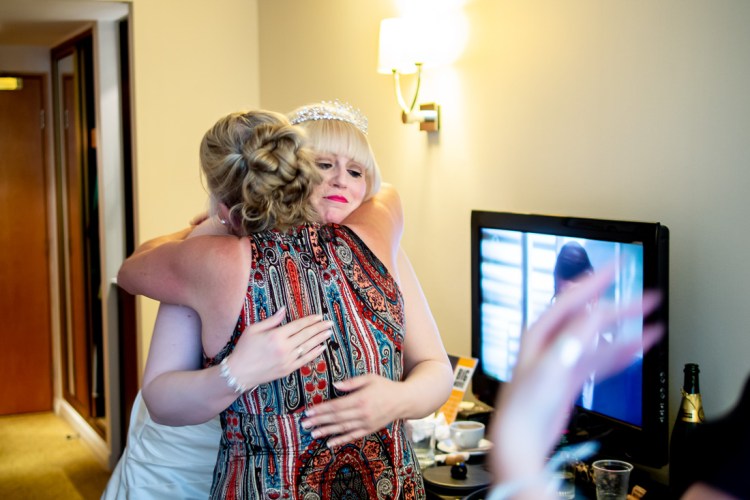 A guest hugs the bride ahead of a wedding at the Meon Valley Hotel, near Southampton, in Hampshire.