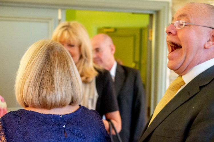 A guest laughs during a wedding at the Meon Valley Hotel, near Southampton, in Hampshire.