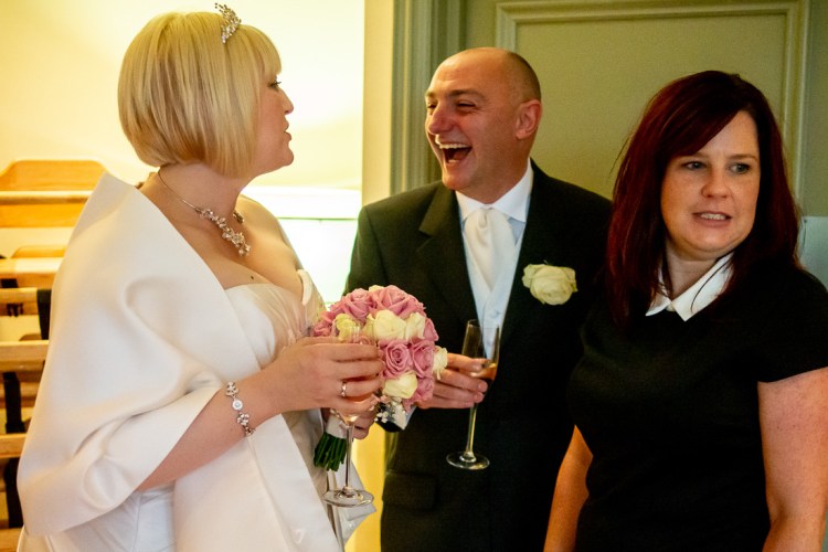 THe groom laughs with the bride during a wedding at the Meon Valley Hotel, near Southampton, in Hampshire.