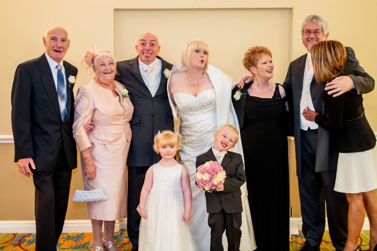 A fun portrait of the wedding party, during a wedding at the Meon Valley Hotel, near Southampton, in Hampshire.
