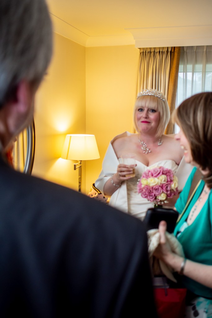The bride smiles at her father, ahead of a wedding at the Meon Valley Hotel, near Southampton, in Hampshire.
