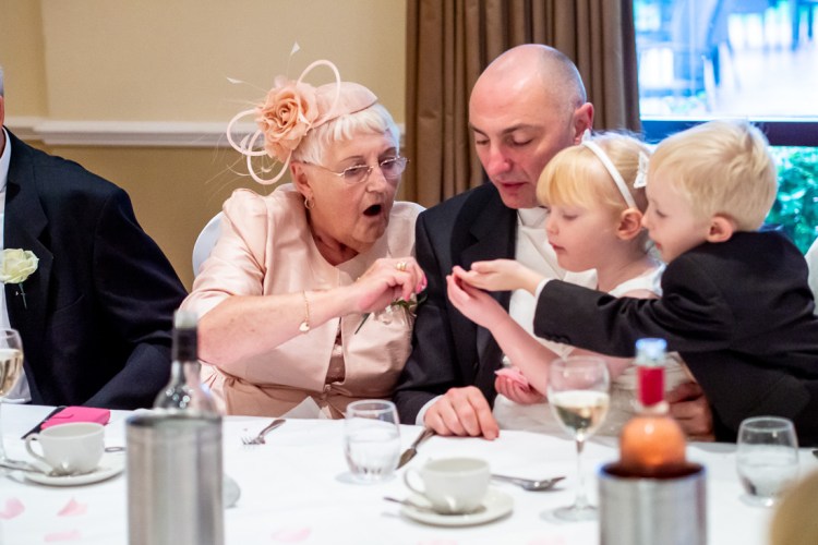 The grandmother and groom entertain children during a wedding at the Meon Valley Hotel, near Southampton, in Hampshire.