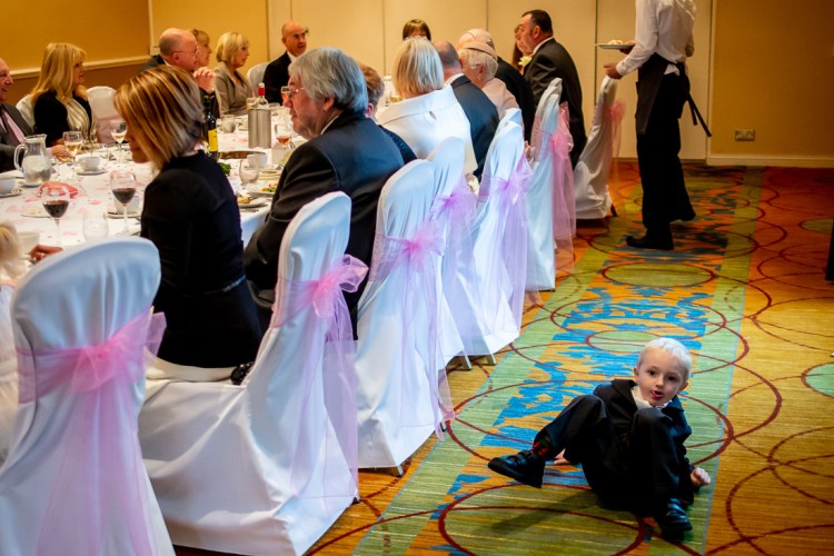 A young guest falls on the floor, during a wedding at the Meon Valley Hotel, near Southampton, in Hampshire.