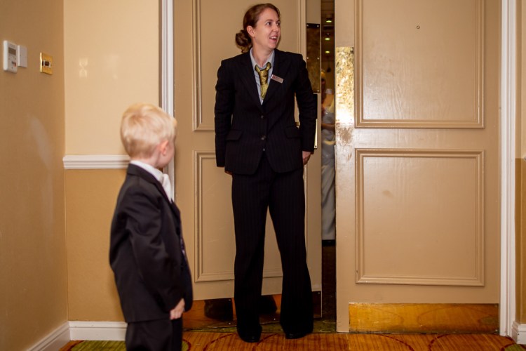 A young guest waiting for the bride during a wedding at the Meon Valley Hotel, near Southampton, in Hampshire.