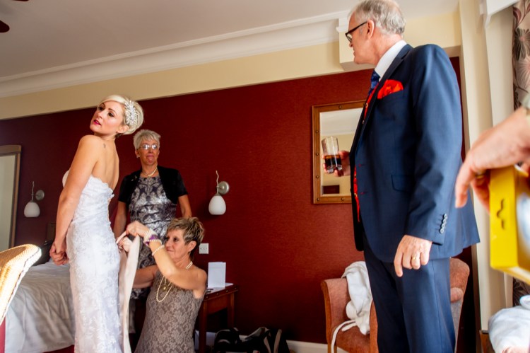 The father-of-the-bride looks proudly on during the bridal preparations, ahead of a wedding at the Old Ship Hotel in Brighton, East Sussex.