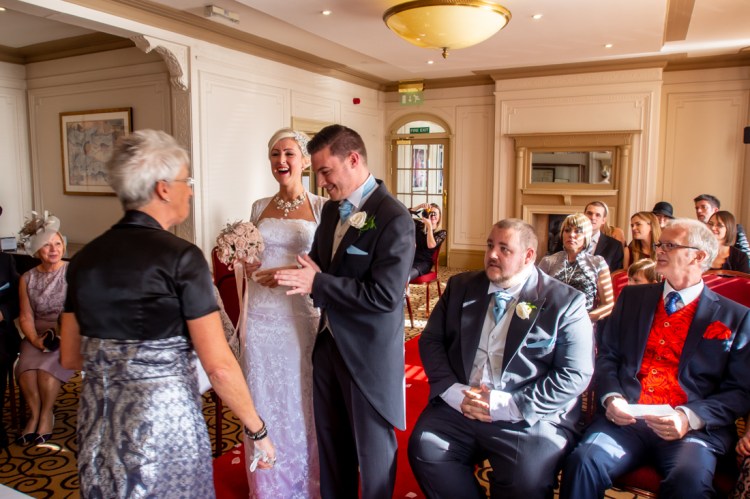 The bride laughs during the wedding ceremony at the Old Ship Hotel in Brighton, East Sussex.