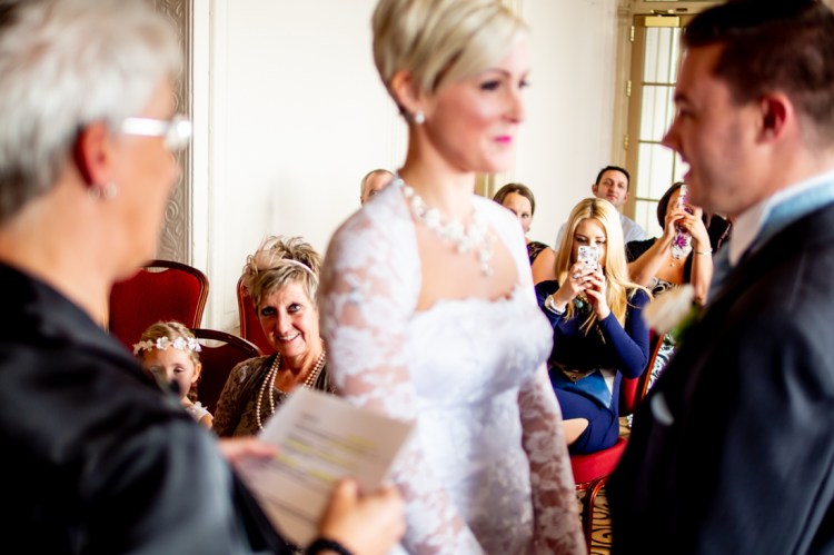 Guests look on as the bride and groom gaze at one another during the wedding ceremony at the Old Ship Hotel in Brighton, East Sussex.