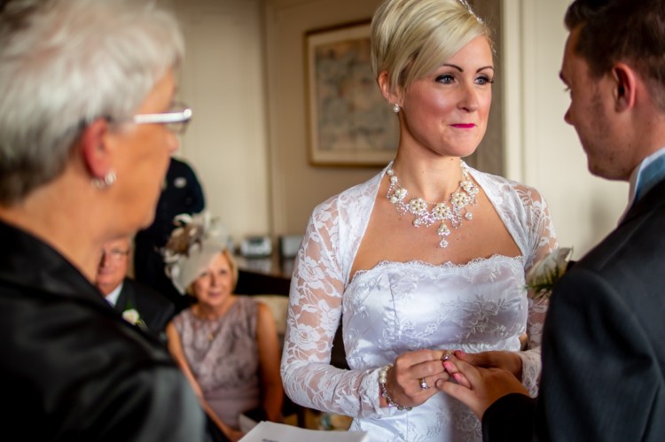 The bride looks lovingly at the groom during the wedding ceremony at the Old Ship Hotel in Brighton, East Sussex.
