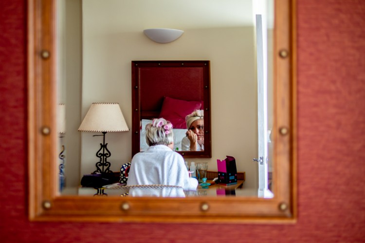 The bride applies makeup ahead of a wedding at the Old Ship Hotel in Brighton, East Sussex.