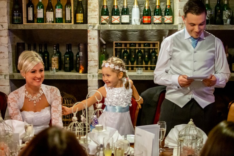 The flower girl is amused during the groom's speech, at the wedding ceremonyat the Old Ship Hotel in Brighton, East Sussex.