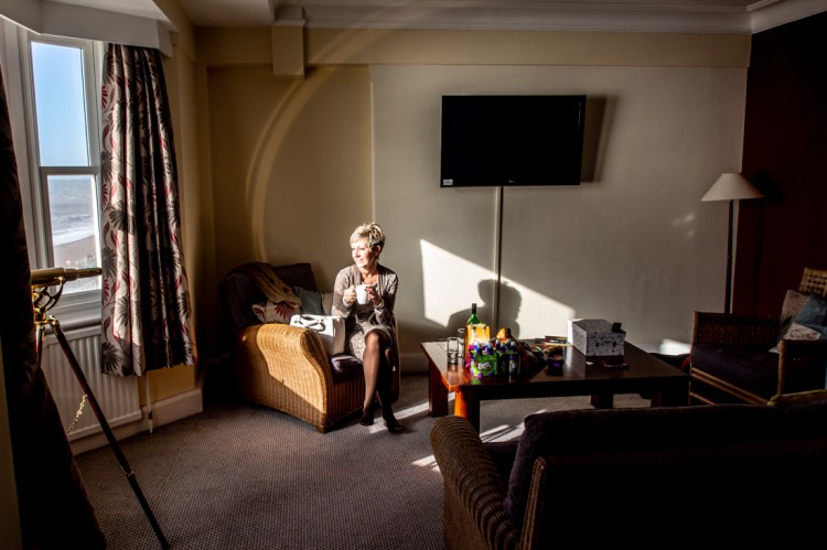 The mother-of-the-bride enjoys an early morning coffee, ahead of a wedding at the Old Ship Hotel in Brighton, East Sussex.