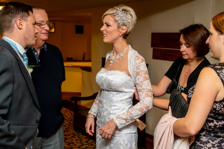 Guests adjust the bride's dress as she chats, during the wedding ceremonyat the Old Ship Hotel in Brighton, East Sussex.