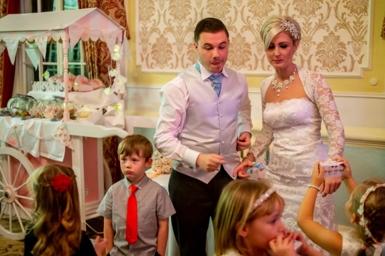 The bride and groom with young guests during the evening wedding reception at the Old Ship Hotel in Brighton, East Sussex.