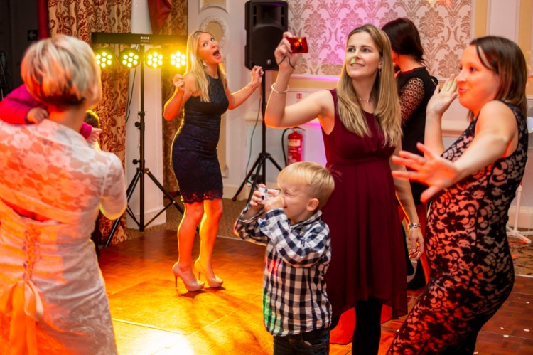 Guests taking photos of the bride on the dancefloor, during the evening wedding reception at the Old Ship Hotel in Brighton, East Sussex.