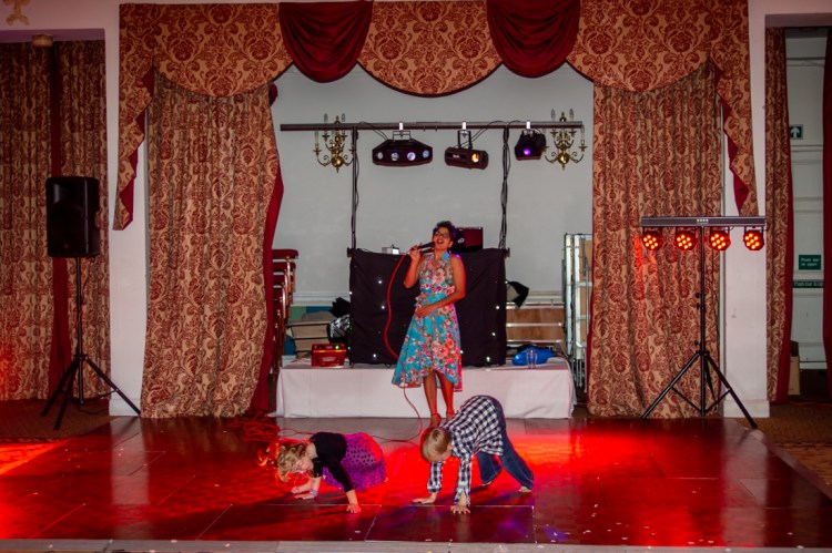 Young guests and the singer during the evening wedding reception at the Old Ship Hotel in Brighton, East Sussex.