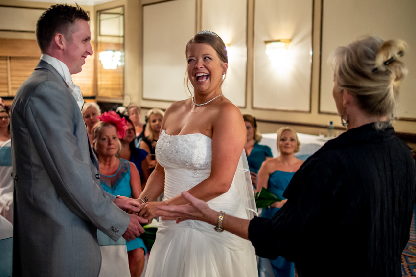 Wedding photojournalism of a laughing bride during a wedding at the Holiday Inn in Brighton, East Sussex. Taken by Bristol wedding photographer, Darren Lehane.